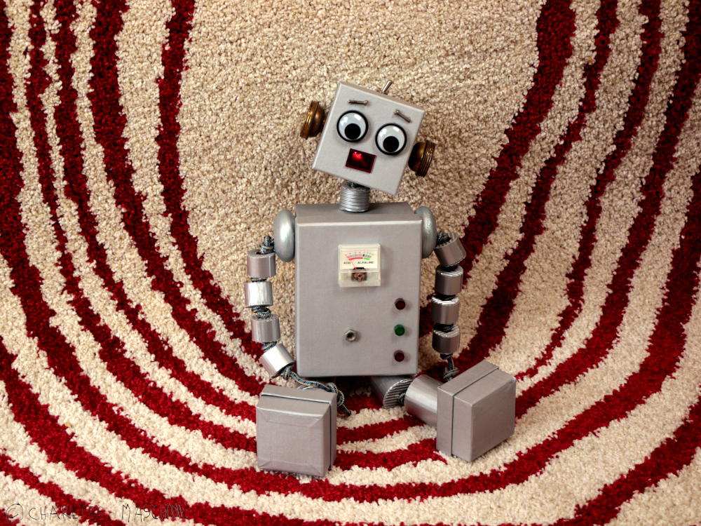 robot puppet – cardboard boxes, wooden beads, silver varnish, electronics; Charlie age 7